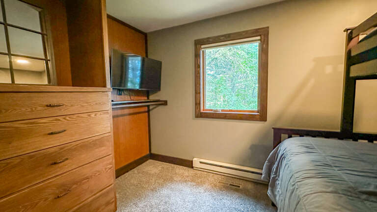 Unwind in your peaceful bedroom with a garden view, wood furnishings, and all the comforts you need for a restful night.