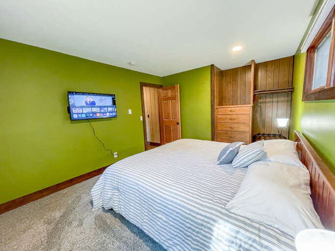 Unwind in your vibrant bedroom with a plush bed, smart TV for entertainment, and ample storage—your personal retreat after a day of adventure.