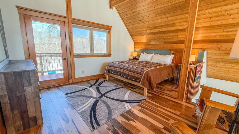 Drift off to sleep surrounded by warm wood and cozy mountain views streaming through your private balcony door.