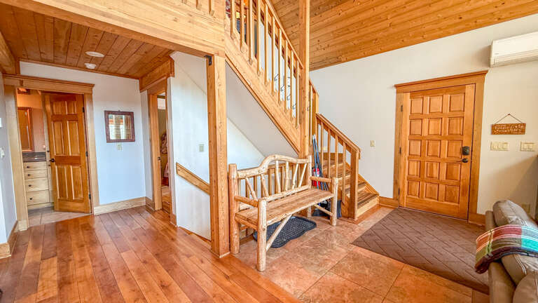 Step into your cozy cabin retreat where warm wood surrounds you from floor to ceiling, creating the perfect mountain getaway atmosphere.