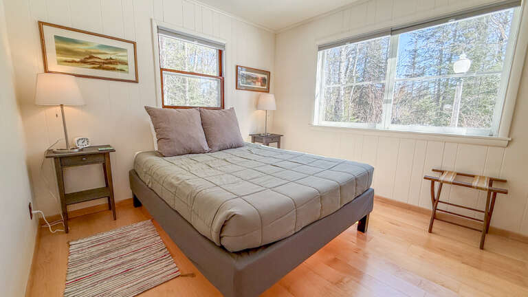 Drift off peacefully in your cozy bedroom, where soft linens and warm wood floors create the perfect retreat after exploring the outdoors.