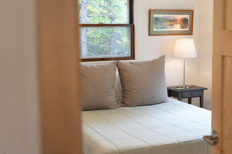Drift off surrounded by natural light streaming through your windows, cozy pillows welcoming you into comfort, and the soft glow of your bedside lamp illuminating quiet moments.