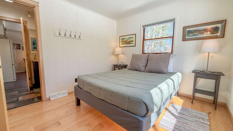Rest peacefully in your cozy bedroom with soft linens, warm wood floors, and natural light streaming through the window for a perfect night's sleep.