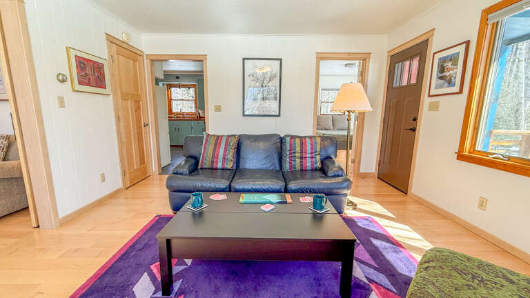 Sink into your comfortable leather sofa and enjoy the bright, spacious living room with its colorful accents and natural light.