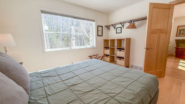 Wake up in your peaceful bedroom with forest views through large windows, plus smart storage cubbies to keep your stay organized.