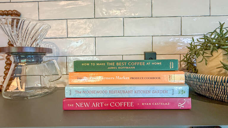 A cozy culinary corner awaits, complete with a pour-over coffee carafe and curated cookbooks for your morning brewing ritual.