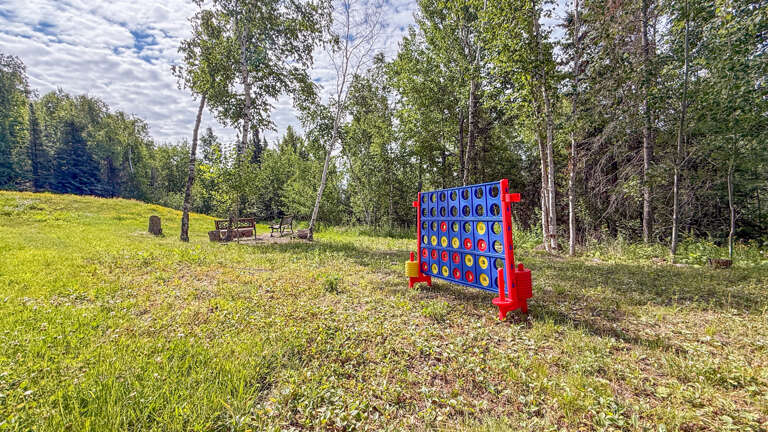 Enjoy friendly competition with a giant outdoor game set on the lush lawn, surrounded by towering trees and fresh mountain air.