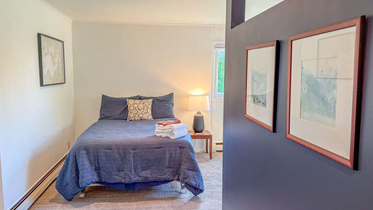 Unwind in your peaceful bedroom, where soft linens, a calming color palette, and natural light through the window invite deep rest and relaxation.