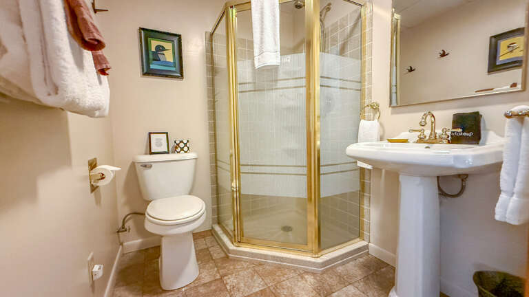 Refresh and unwind in your elegantly appointed bathroom with its spacious walk-in shower and classic pedestal sink. Plush towels and thoughtful touches make this a peaceful retreat.