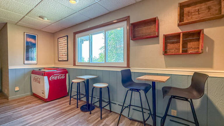 Challenge your friends to a game in your own space, with a vintage cooler stocked and ready for downtime. Open-shelf storage and plenty of seating make it easy to unwind on your terms.