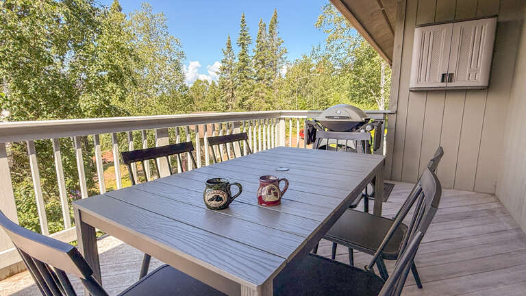 Sip your morning coffee on this private balcony, gazing out at the surrounding forest. With your own outdoor dining table and grill, you can enjoy meals in the crisp mountain air.