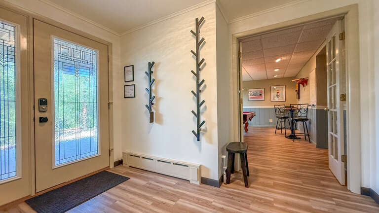 Step inside to gleaming hardwood floors and sun-dappled natural light. Your private entryway offers plenty of coat hooks for easy unpacking, setting the stage for a relaxing getaway.