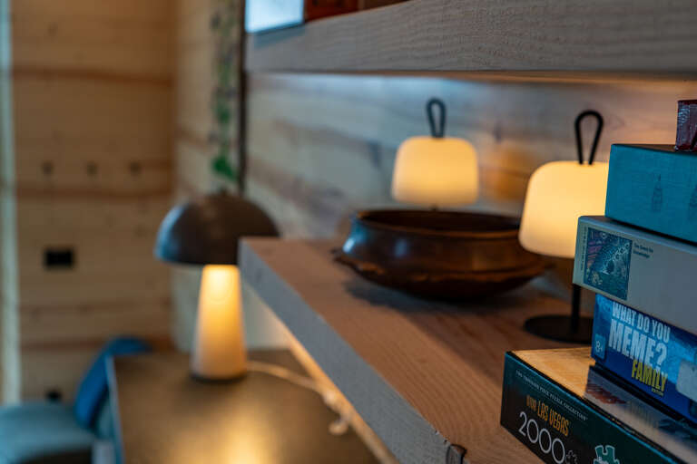 Warm ambient lighting creates an inviting atmosphere as you explore your new favorite reads, with thoughtful touches that make your stay feel like home.