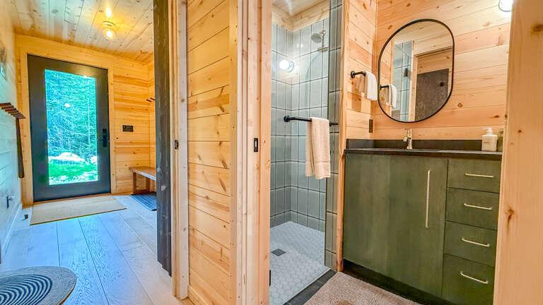Step into your private retreat with sleek modern finishes and natural wood warmth. Your spa-like shower awaits after a day of adventure, while thoughtful touches and ample storage keep everything perfectly in place.
