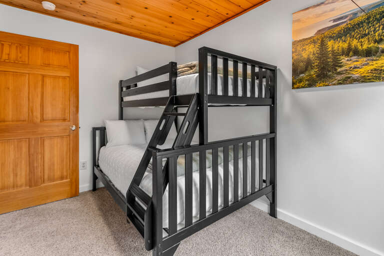 Cozy sleeping quarters with a sturdy bunk bed and warm wood accents, perfect for the kids or extra guests during your mountain getaway.