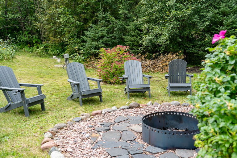 Gather around the fire pit in your own private backyard retreat, surrounded by forest greenery and comfortable Adirondack chairs—perfect for evening s'mores and starlit conversations.
