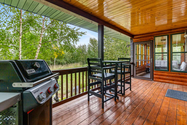 Enjoy modern cooking outside on this covered patio complete with outdoor deck seating and views of the secluded Superior National forest.