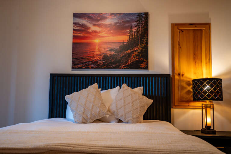 Sink into plush bedding and let the warm glow of the bedside lamp lull you into pure relaxation. Your peaceful retreat awaits.