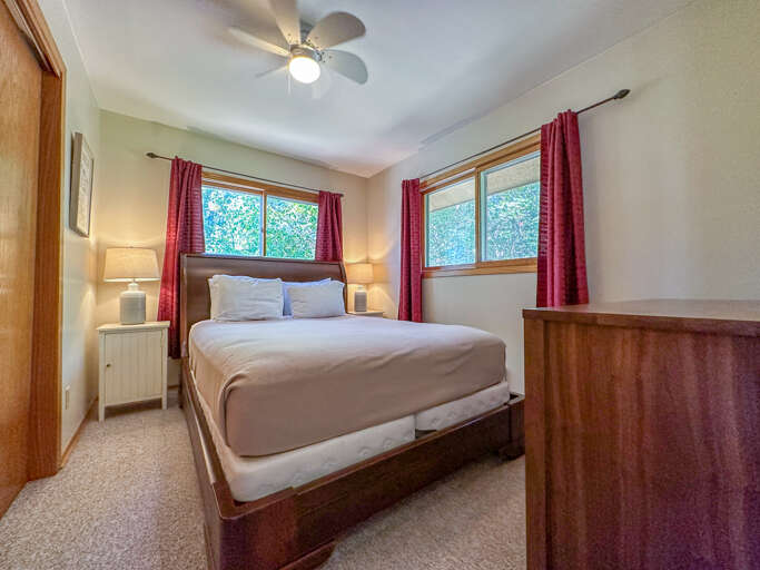The bedroom features a queen sized bed.