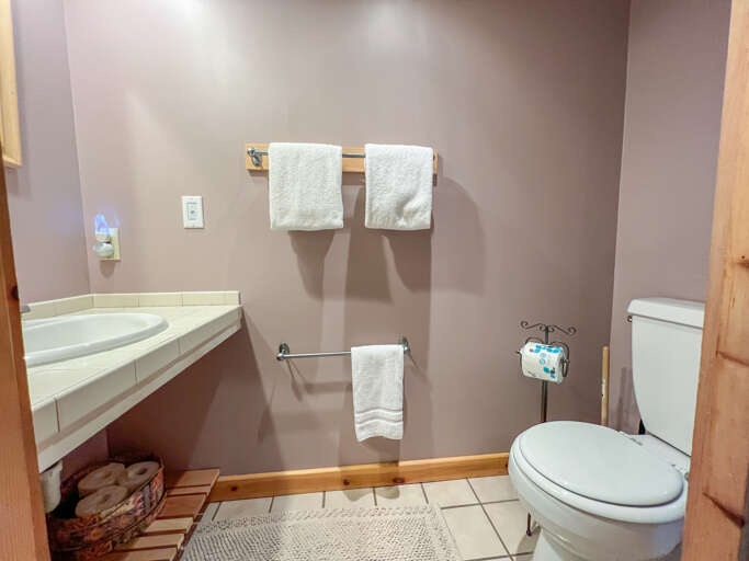 There is a toilet and sink on the left. There is a toilet and sink on the left.