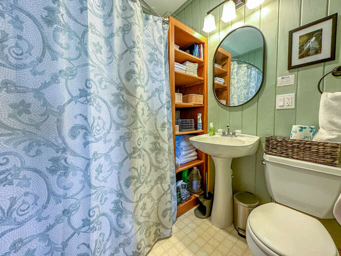 The bathroom has a shower/tub combo.