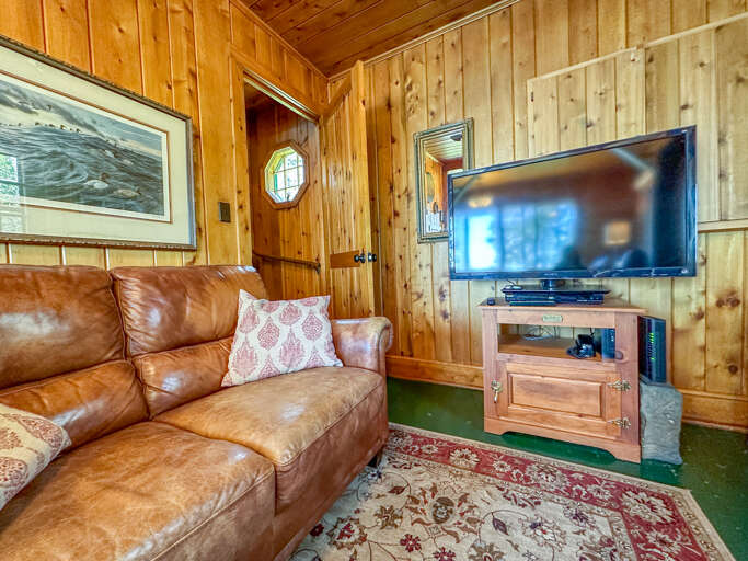 TV in the living room and the staircase leading to the second floor.