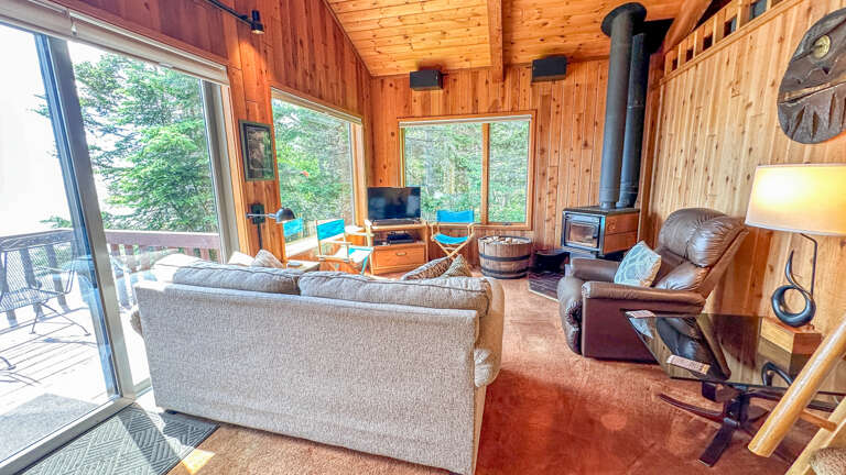 Cozy living room with TV and wood-burning stove. Cozy living room with TV and wood-burning stove.