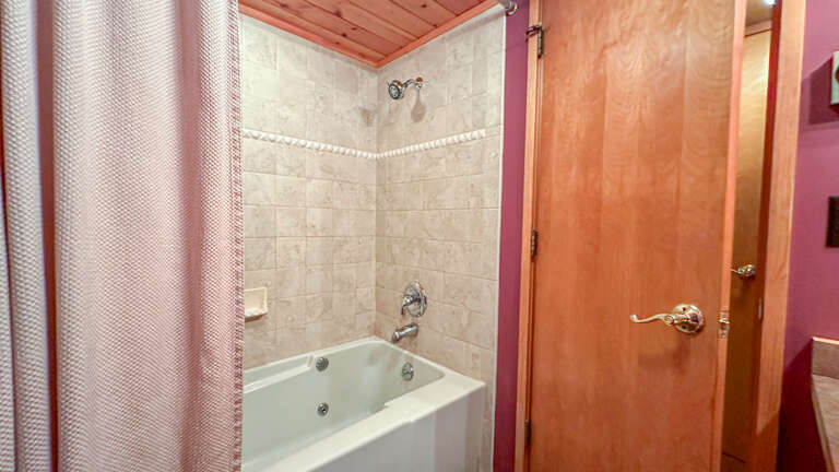 Full bathroom with jetted tub and shower.