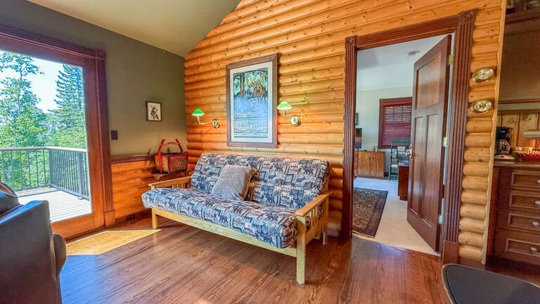 The futon serves as the third sleeping area in this home.