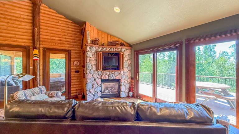 Stone surround fireplace and TV in the living room.