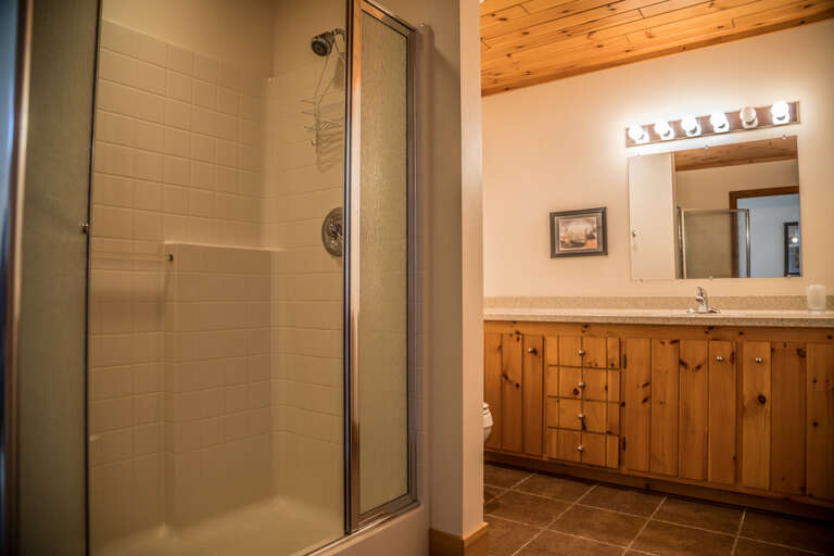 This bathroom is located on the upper level and it offers a walk-in shower.