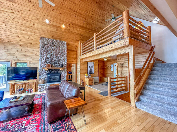 Head up the stairs in the living room to get to the loft bedroom.