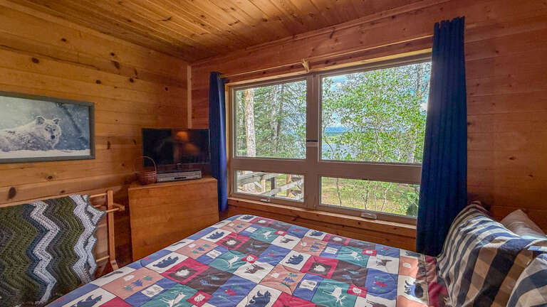 Wake up to stunning lake and forest views right from your bed. Natural pine walls and large windows bring the outdoors inside, creating your perfect mountain retreat.