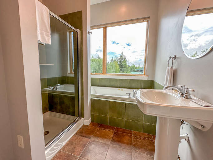 This bathroom has a jetted tub and separate shower