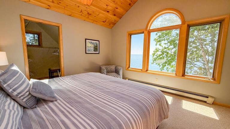 Wake up to stunning lake views framed by charming wood-trimmed windows. Enjoy the vaulted pine ceiling and cozy seating nookâyour peaceful retreat awaits.
