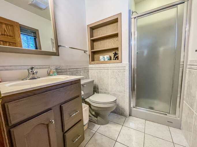 The attached bathroom also offers a vanity and walk in shower.