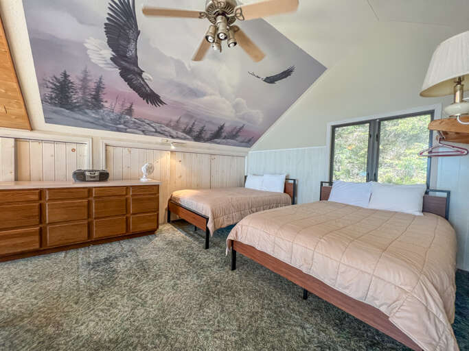 This bedroom located in the loft area is open to the living room.