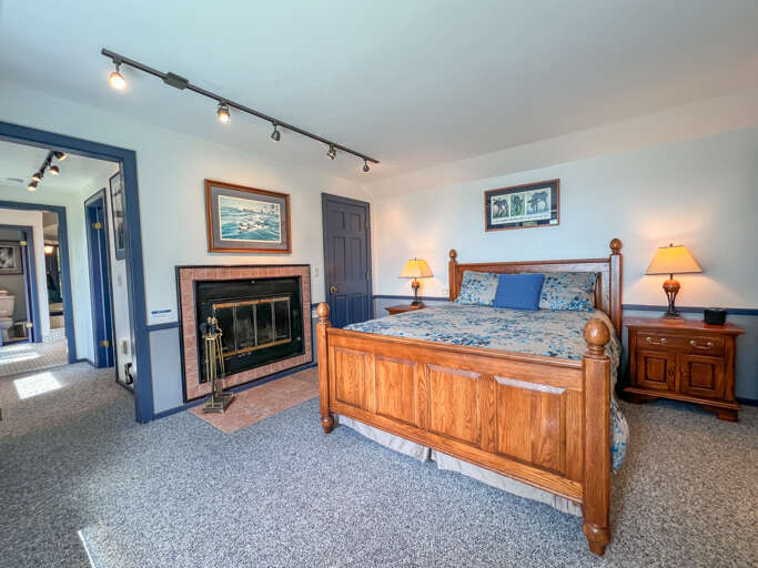 Bedroom 1 has a queen bed and wood burning fireplace.