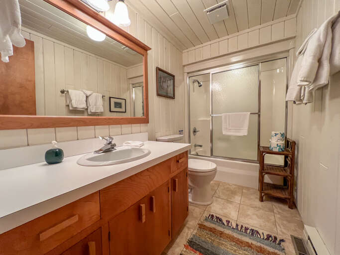 This bathroom is located by the guest bedrooms and sloe offers a vanity and shower-tub combo. It was also updated in 2022.
