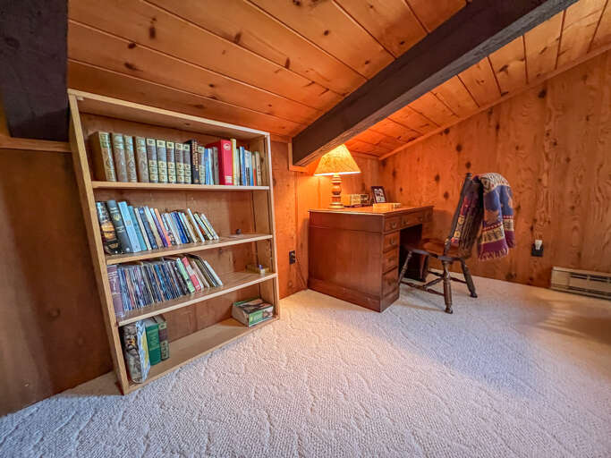 There is a small library and desk space in the third bedroom.