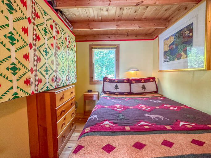 The bedroom has a full sized bed. The bedroom has a full sized bed.