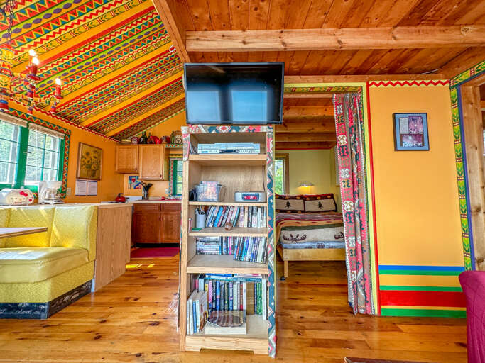 The bedroom is located off of the living room. The bedroom is located off of the living room.