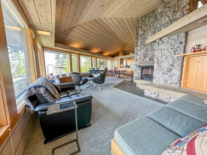 The living room has a massive stone surround fireplace.