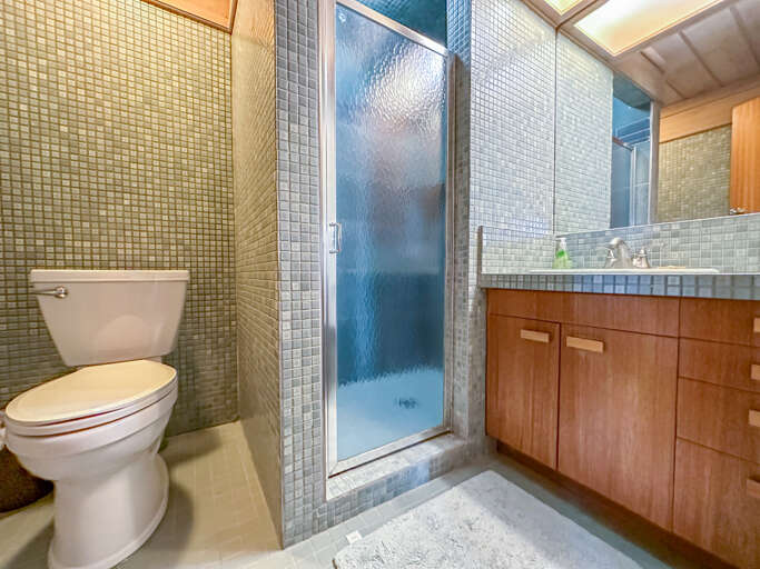 Bedroom 2 has a shower and is located in the lower level.