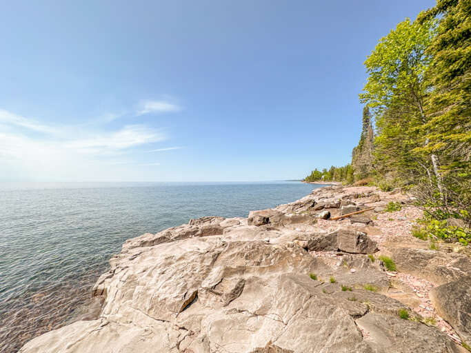 The shoreline is entirely ledge rock and runs the length of the home and then some.