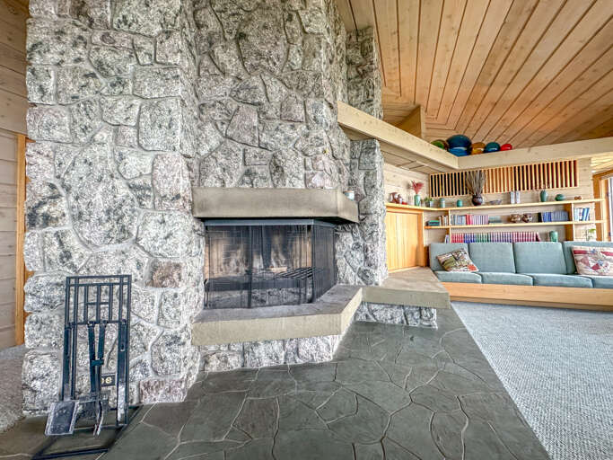 Stone surround wood-burning fireplace.