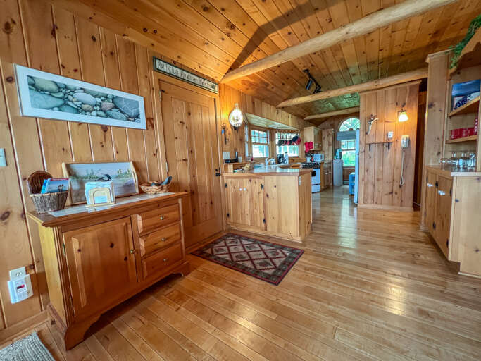The main door to the cabin is between the dining area and the kitchen.
