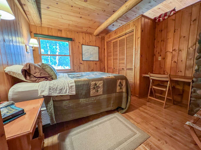 There is a small desk area in the first guest bedroom.