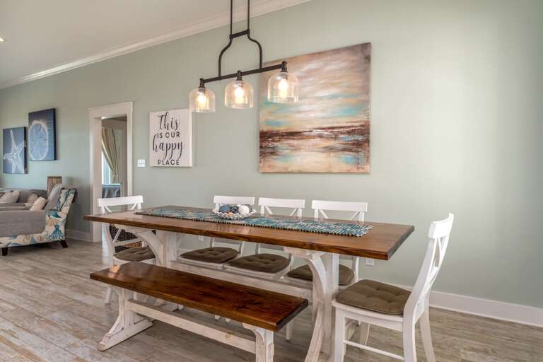 Modern Dining Room With Wooden Table, Benches, And Decorative Wall Art Modern Dining Room With Wooden Table, Benches, And Decorative Wall Art
