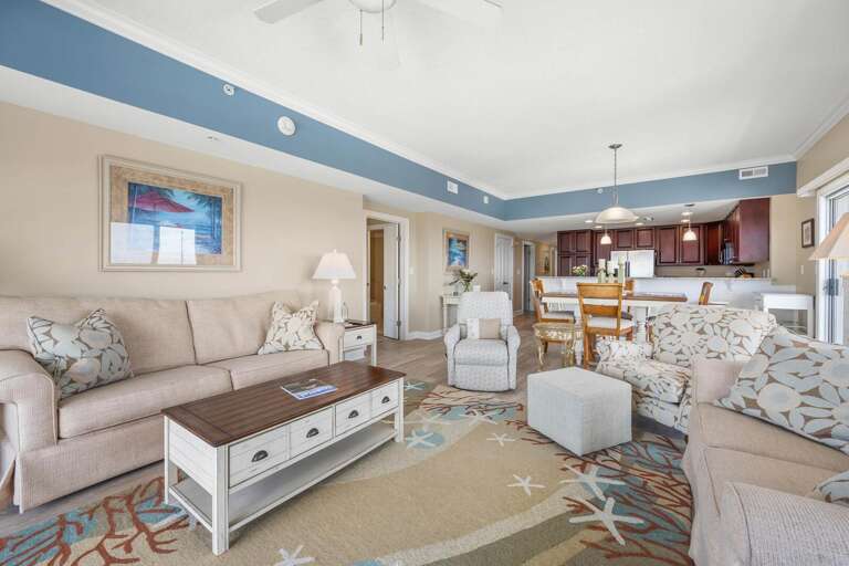 Spacious Living Area Leading Into Kitchen, Pastel Palette, Plush Seating, Ceiling Fan